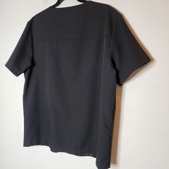 Jaanuu black scrub top. 1 zip chest pocket.  Short sleeve v-neck. Women's size L - Picture 13 of 14